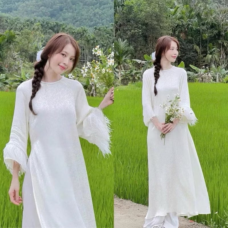 Áo dài gấm dáng xuông tay loe đính viền lông vũ