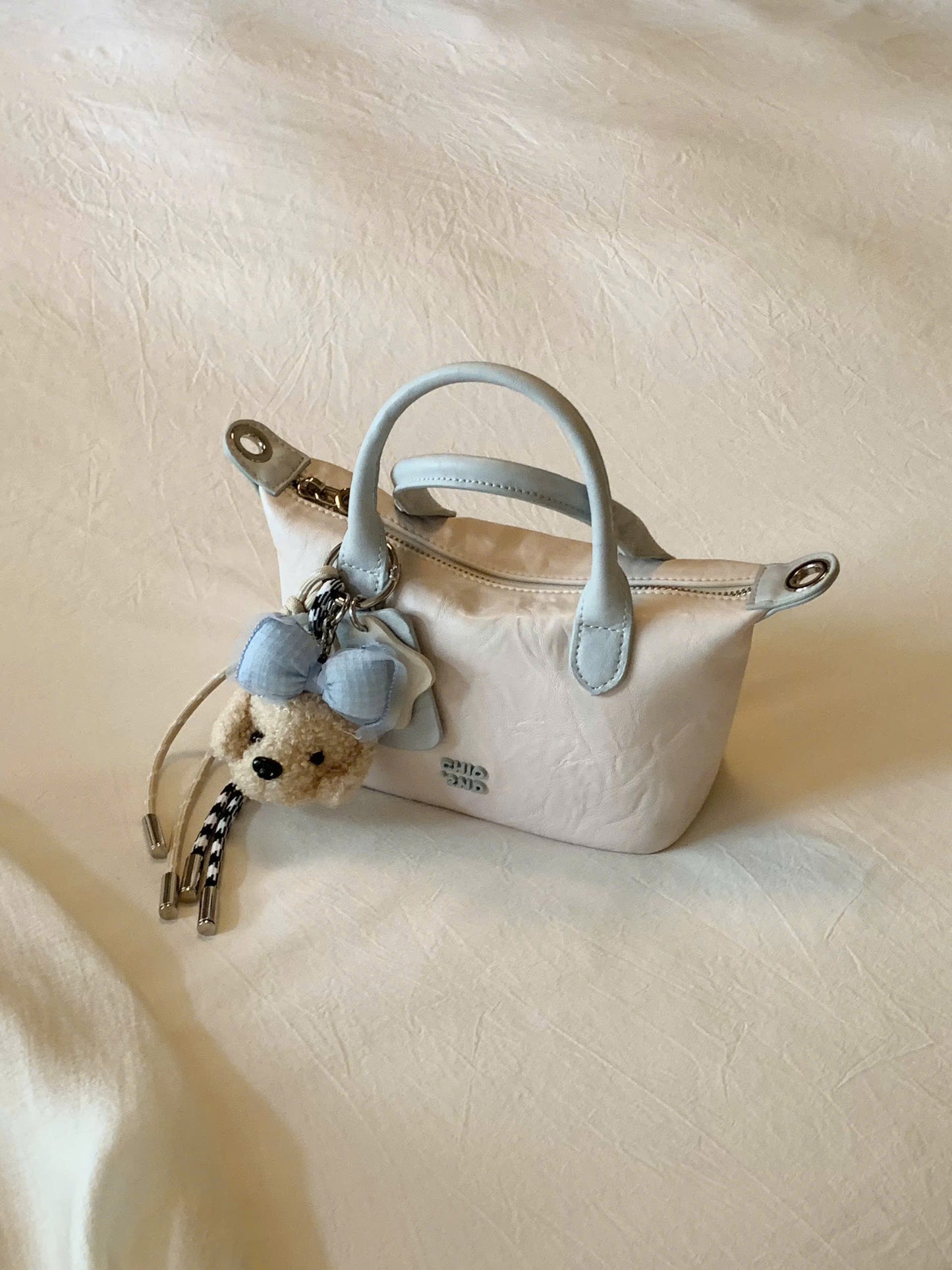 Túi cầm tay đeo vai charm cún nơ Chio'2nd
